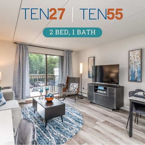 a spacious living room with a large sliding glass door leading to a patio